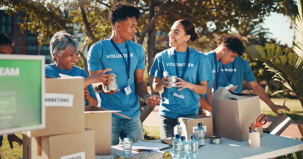 Group of smiling people gathered in a circle representing a non-profit community