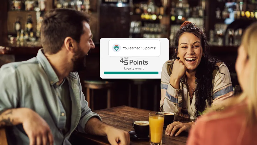 Bartender taking a card payment from a guest, with RestroGreen loyalty points shown