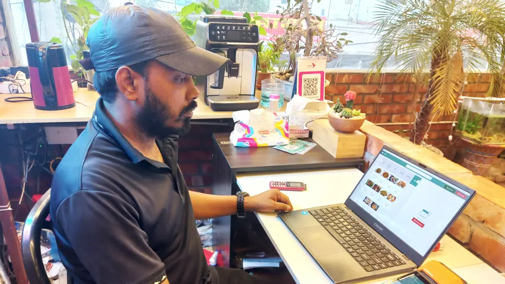 A bangladeshi restaurant manager using quickly product softwares